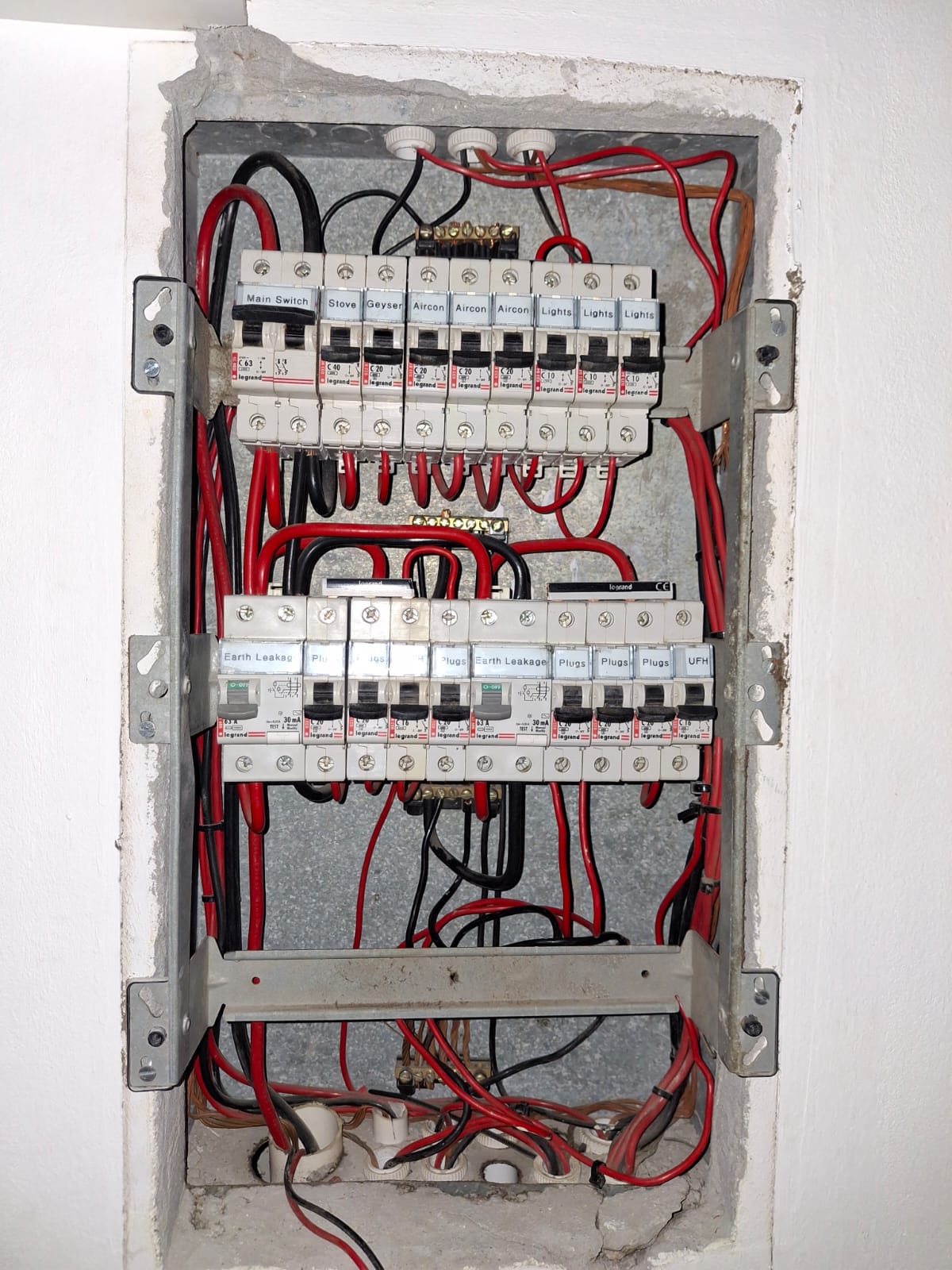 Domestic distribution board with labelled circuit breakers for stove, geyser, aircon, lights and plugs